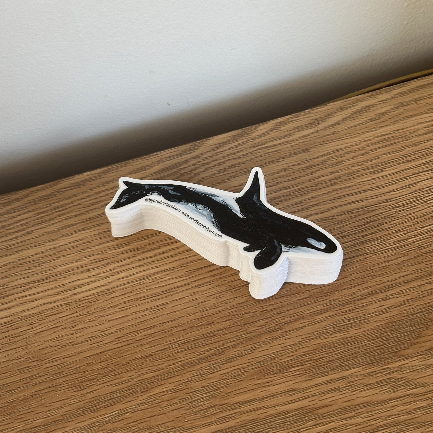 Decorative orca vinyl sticker on a wooden surface