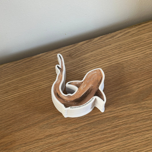 Vinyl sticker with shark design on a wooden surface