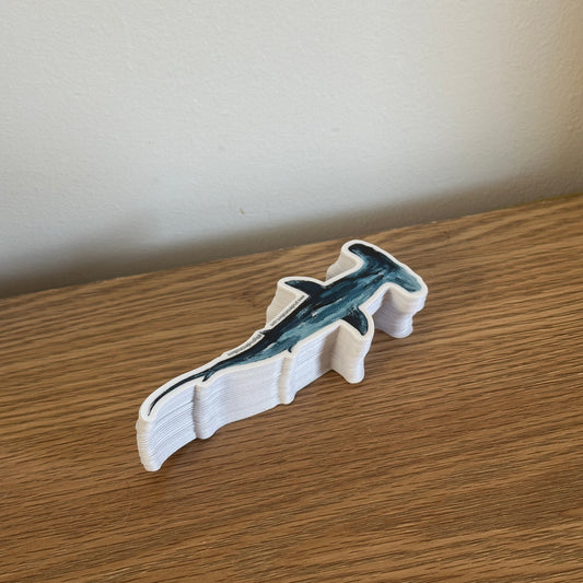 Sticker of a shark on a wooden surface