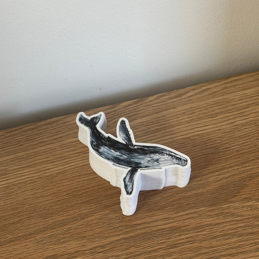 humpback whale vinyl sticker on a wooden surface