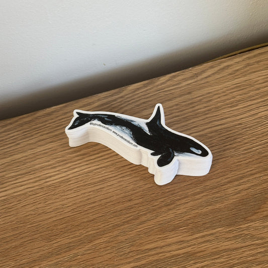 Decorative orca vinyl sticker on a wooden surface